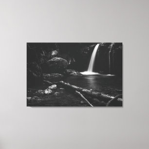 Minimalistic waterfall behind broken tree in black canvas print