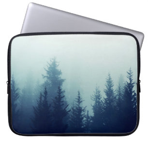 Misty fog in pine forest on mountain slopes. Colou Laptop Sleeve