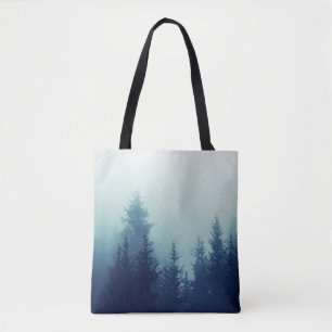 Misty fog in pine forest on mountain slopes. Colou Tote Bag