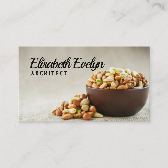 Mix of different nuts in a wooden cup against the business card (Front)