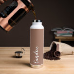Mocha Personanlized Wedding Bridesmaid Water Bottle<br><div class="desc">Gift your wedding bridesmaid or maid of honour with this trendy, vacuum Insulated water bottle that features her name in white, stylised script on a trendy mocha brown colour background designed to match your wedding colour scheme. Personalise bottle by editing and replacing name with your own as desired. Select your...</div>