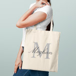 Modern and Elegant Black Personalised Monogram Tote Bag<br><div class="desc">Modern and elegant tote bag features a simple and minimal custom grey and black (colours can be modified) personalised monogram design that can be personalised with an initial and name in script. Perfect gift for your wedding party - maid of honour, bridesmaids, mothers of the bride and groom, and flower...</div>