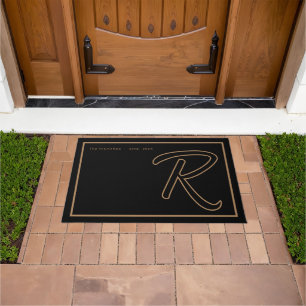 Modern Black Gold Monogram Script Family Name Doormat