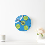 Modern Blue Court Tennis Ball Racket Round Clock<br><div class="desc">Minimalist tennis themed design in blue and hues. Green tennis balls and racket design themed gifts for a tennis player.</div>