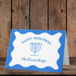 Modern Bold Wavy Border Personalised Blue Hanukkah Card<br><div class="desc">Send your warmest Hanukkah wishes with these elegant, customisable greeting cards. Featuring a vibrant blue background, a classic menorah illustration, and a wavy border design, these cards offer a modern twist on traditional Hanukkah themes. Personalise with your family name for a truly special touch, making each card a memorable keepsake...</div>