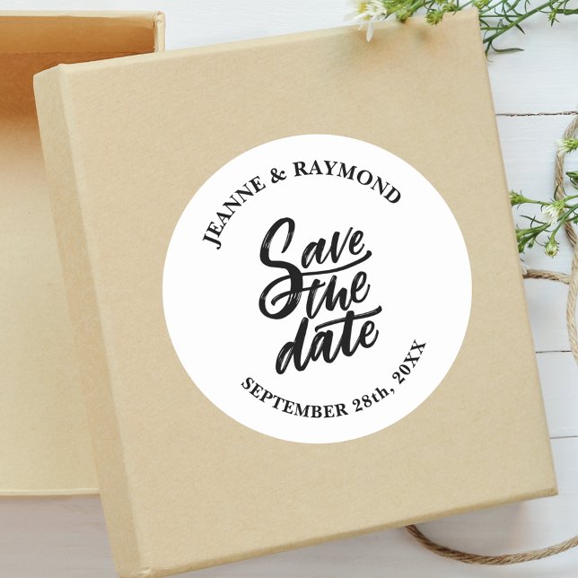 Modern Brush Lettered Custom Wedding Save the Date Classic Round Sticker (Brush lettered save the date sticker brings timeless beauty to invitation envelopes.)