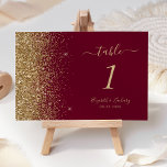 Modern Burgundy Red Gold Glitter Edge Wedding Table Number<br><div class="desc">The left-hand edge of this elegant modern wedding table number features a gold faux glitter design. The customisable text combines pale gold-coloured handwriting,  copperplate and italic fonts on a burgundy red background.</div>