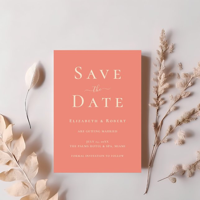 Modern Chic Coral Pink Typography Save the Date Invitation (Modern Chic Coral Pink Typography Save the Date Invitation on a table with dry soft pink flowers.)