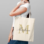 Modern Elegant Gold Black Personalised Monogram Tote Bag<br><div class="desc">Modern and elegant tote bag features a simple and minimal custom gold and black (colours can be modified) personalised monogram design that can be personalised with an initial and name in script. Perfect gift for your wedding party - maid of honour, bridesmaids, mothers of the bride and groom, and flower...</div>