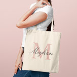Modern Elegant Rose Gold Personalised Monogram Tote Bag<br><div class="desc">Modern and elegant tote bag features a simple and minimal custom rose gold and black (colours can be modified) personalised monogram design that can be personalised with an initial and name in script. Perfect gift for your wedding party - maid of honour, bridesmaids, mothers of the bride and groom, and...</div>