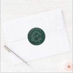 Modern Emerald Green Leafy Crest Monogram Wedding Classic Round Sticker<br><div class="desc">We're loving this trendy, modern emerald green wedding Envelope Seal! Simple, elegant, and oh-so-pretty, it features a hand drawn leafy wreath encircling a modern wedding monogram. It is personalised in elegant typography, Finally, it is trimmed in a delicate frame. View suite here: https://www.zazzle.com/collections/emerald_green_leafy_crest_monogram_wedding-119957580948924617 Contact designer for matching products to complete...</div>