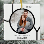 Modern First Christmas Engaged Photo Ceramic Ornam Ceramic Ornament<br><div class="desc">This modern First Christmas Engaged Photo Ornament is decorated with the word JOY in black on a white background.
Easily customisable with your photo and name.</div>