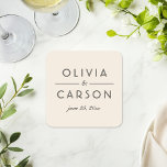 Modern Ivory and Black Wedding Monogram Square Paper Coaster<br><div class="desc">Elegant wedding coasters featuring the couple's names in bold black typography with a graceful script ampersand on a warm ivory background. The wedding date completes this polished modern monogram design. A sophisticated reception table accent or keepsake favour with a neutral,  timeless feel. Customise with your details.</div>