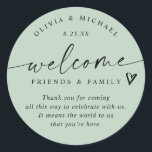 Modern Light Sage Green Wedding Welcome Hotel Bag Classic Round Sticker<br><div class="desc">Light Sage Hotel Bag Stickers: Soft and fresh, these light sage modern handwriting wedding welcome stickers bring a natural elegance to your wedding weekend. Each 3-inch round sticker features the phrase “welcome friends & family” with a small heart accent and space for your short message. The couple’s names and wedding...</div>