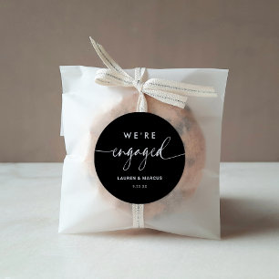 Modern Minimalist Black Calligraphy We're Engaged Classic Round Sticker