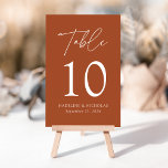 Modern Minimalist Terracotta Wedding Table Number<br><div class="desc">Elegant wedding table number card displaying the word "Table" in a white handwritten script with the table number, your names, and wedding date shown below with a terracotta background. The design repeats on the back. To order the table number cards, simply type each number and add it to your cart....</div>