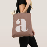 Modern Mocha Brown Bold Retro Monogram Initial Tote Bag<br><div class="desc">A bold and contemporary tote bag featuring an earthy mocha brown background with a striking white lowercase letter in modern typography. Perfect for everyday use, shopping, work, or as a statement accessory, this eye-catching design blends minimalism with a retro-inspired aesthetic. Ideal for typography lovers and those who appreciate stylish, unique...</div>