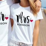 Modern Mrs Calligraphy Heart Monogram T-Shirt<br><div class="desc">This beautiful "Mrs." tee features bold brush calligraphy with a sweet red heart accent and a customisable last name in clean uppercase lettering. The oversized script on white creates a modern, romantic look perfect for honeymoon travel, bridal showers, or everyday newlywed style. Edit the last name to personalise this monogram...</div>
