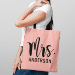 Modern Mrs Pink Black Script Wedding Monogram Tote Bag<br><div class="desc">Custom wedding tote bag features a bold and modern Mrs script monogram of the bride's married last name in stylish black text with blush pink background. Two-sided design.</div>