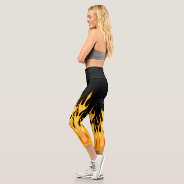 Modern orange yellow fire flames on black capri leggings (Left)