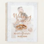 Modern Photo White & Gold Wedding Plans Planner<br><div class="desc">Start your wedding plans with this elegant and sophisticated essential item. This design features a marble background overlaid with your favourite couples photo with a soft transparent overlay. Complete with gold text and wedding rings. Customise for your perfect wedding planner.</div>