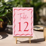 Modern Pink and Red Wavy Frame Wedding Table Number<br><div class="desc">Add a stylish touch to your wedding celebration with these Modern Wavy Frame wedding table cards! The retro design displays "Table" in a handwritten red script with the table number shown below. A red wavy border surrounds the table number contrasting with a light pink background. The design repeats on the...</div>