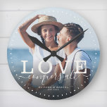 Modern Quote Love Wedding Photo Newlywed Script Round Clock<br><div class="desc">Custom modern chic photo clock with hand-lettered script and modern typography reading:' Love conquers all ' alongside your custom names and wedding date. Personalise with your favourite photo and information. Great gift for newlyweds,  an anniversary or Valentine's Day!</div>