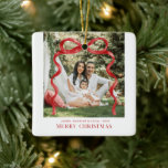 Modern Red Bow Merry Christmas Photo Ceramic Ornament<br><div class="desc">Celebrate the season with this Modern Red Bow Merry Christmas Photo Ornament. Featuring a stylish red ribbon illustration and a space to showcase your favourite photo, this elegant ceramic ornament adds a personal and festive touch to your holiday décor. Whether it’s a keepsake for your own tree or a thoughtful...</div>