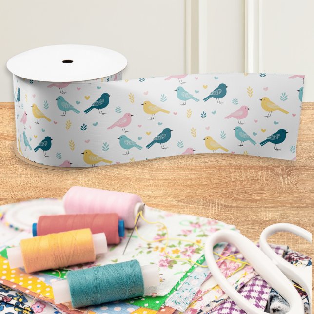 Modern Scandi Bird Pattern Ribbon Satin Ribbon (A ribbon with modern pattern of Scandi-style birds in blue, yellow and pink on a white background)