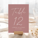 Modern Script Dusty Rose Wedding Table Number Card<br><div class="desc">Simple, modern wedding table number cards featuring "Table" displayed in a handwritten white script with a dusty rose background (or a colour of your choosing). To order the dusty rose wedding table cards: add your name, wedding date, and table number. Each number needs to be added to your cart individually....</div>