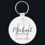 Modern Script Personalised Groomsmen Key Ring<br><div class="desc">Add a personal touch to your wedding with personalised groomsmen keychain. This keychain features personalised groomsmen's name in grey modern script font style and monogram in light grey modern script font style as background with title and wedding date in grey modern sans serif font style on white background. Also perfect...</div>