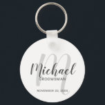 Modern Script Personalised Groomsmen Key Ring<br><div class="desc">Add a personal touch to your wedding with personalised groomsmen keychain. This keychain features personalised groomsmen's name in grey modern script font style and monogram in light grey modern script font style as background with title and wedding date in grey modern sans serif font style on white background. Also perfect...</div>