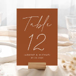 Modern Script Terracotta Wedding Table Number Card<br><div class="desc">Simple, modern wedding table number cards featuring "Table" displayed in a handwritten white script with a terracotta background (or a colour of your choosing). To order the terracotta wedding table cards: add your name, wedding date, and table number. Each number needs to be added to your cart individually. After you...</div>