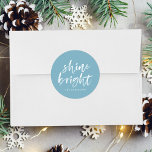 Modern Shine Bright Winter Blue Holiday Classic Round Sticker<br><div class="desc">Add a festive touch to your holiday envelopes and gift boxes with our Shine Bright holiday stickers. The custom holiday stickers feature the words "Shine Bright" in a white,  modern hand-lettered script and a sky blue background. Personalise the stickers by adding your name or custom text below.</div>
