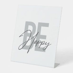 Modern, simple, cool typography of Be Happy Pedestal Sign
