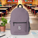Modern Stylish Monogram Typography Purple Printed Backpack<br><div class="desc">A bold and beautiful backpack design with a stylish layout of your name and monogram with classic serifs and a more ornate script typography in a balanced symmetry. The three elements blend together with a sophisticated harmony and create your own personal branding logo. Shown here with a trendy purple background...</div>