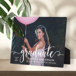 Modern White Script Graduate Photo Graduation Plaque<br><div class="desc">Stylish and elegant graduation plaque sign with easel features a senior photo with "graduate" white script overlay. Personalise the modern custom text with your grad's name,  school,  and class year. Makes a beautiful keepsake to display in your home!</div>