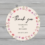Modern Wildflower Beige Wedding Thank You Classic Round Sticker<br><div class="desc">This modern wildflower beige wedding thank you classic round sticker design features a warm beige background adorned with vibrant pink and purple watercolor wildflowers, evoking a sense of timeless romance. The marriage of rustic and elegant boho charm makes this design perfect for couples seeking a modern wildflower aesthetic. Whether you...</div>