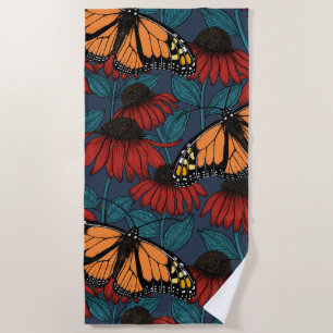 Monarch butterfly on red coneflowers beach towel