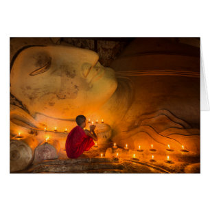 Monk Praying By A Buddha