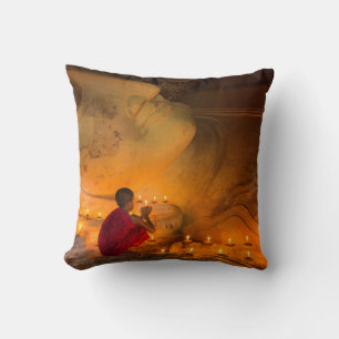 Monk Praying By A Buddha Cushion