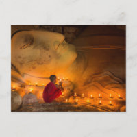 Monk Praying By A Buddha