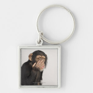 Monkey rubbing its face key ring