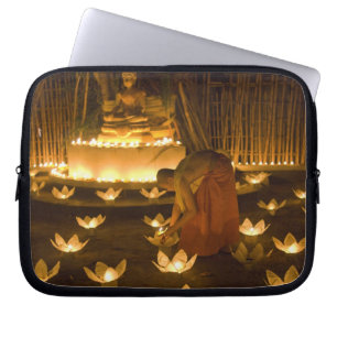 Monks lighting khom loy candles and lanterns for laptop sleeve