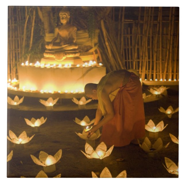 Monks lighting khom loy candles and lanterns for tile (Front)
