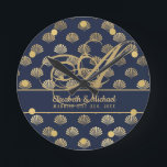 Monogram ART Deco Navy Blue Gold Shells Newlyweds Round Clock<br><div class="desc">Elegant wedding gift for newlyweds featuring their surname monogram as a fancy calligraphy letter,  their first names and the date of marriage. The theme is navy blue with a gold shell pattern art deco style.</div>