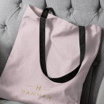 Monogram Blush Pink | Elegant Gold Minimalist Tote Bag<br><div class="desc">A simple stylish custom monogram design in a gold modern minimalist typography on an elegant pastel blush pink background. The monogram initials and name can easily be personalized along with the feature line to make a design as unique as you are! The perfect bespoke gift or accessory for any occasion....</div>