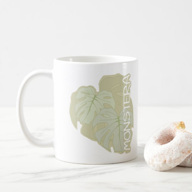 Monstera foliage in soft green coffee mug (With Donut)