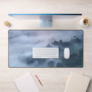 Morning fog rolling through trees desk mat