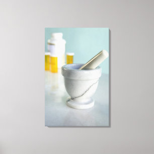 Mortar and pestle, pill bottles in background canvas print